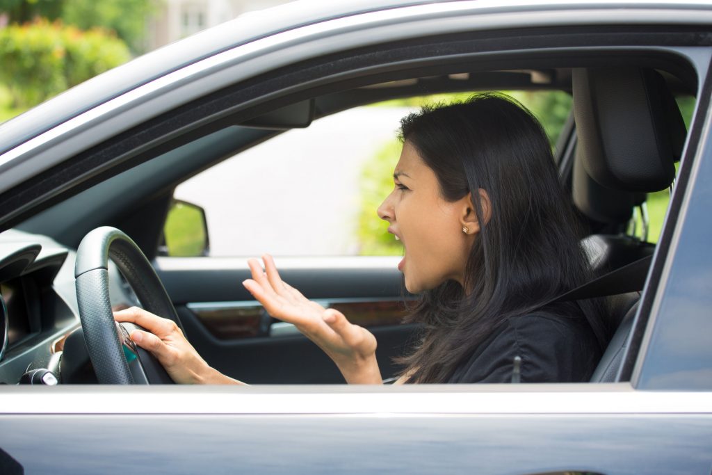 woman exhibiting road rage in car
